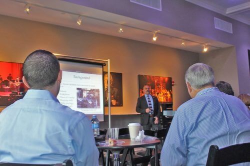 corporate presentation in mpac, man presenting slideshow in business casual