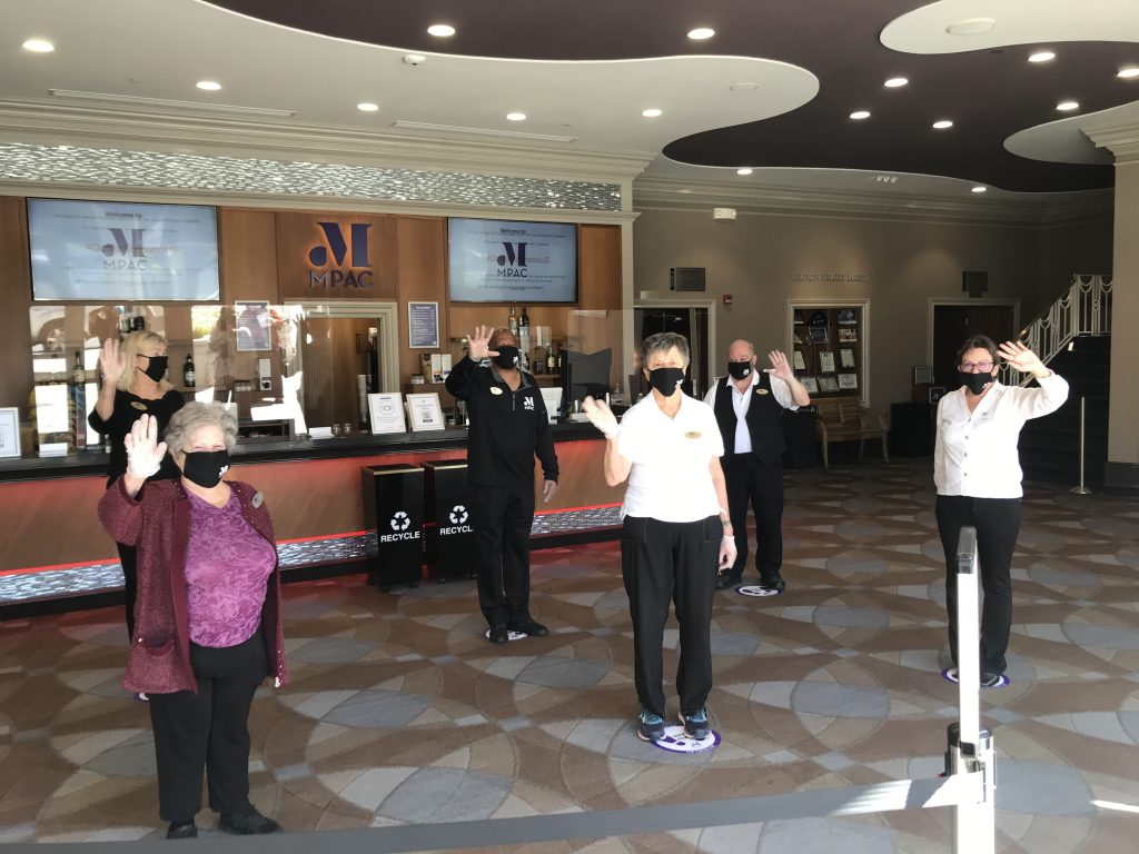 volunteers waving in lobby
