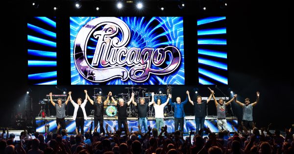 chicago band members on stage holding hands