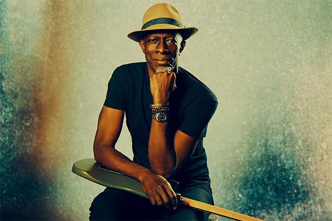 Keb' mo' sitting with guitar