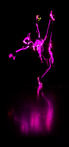 dancer in the dark with lit up costume