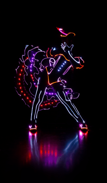 dancer in the dark with lit up costume