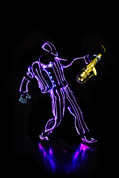 dancer in the dark with lit up costume