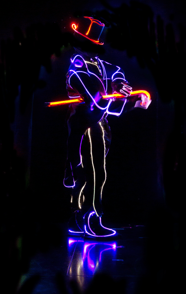 dancer in the dark with lit up costume