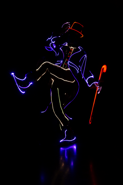 dancer in the dark with lit up costume
