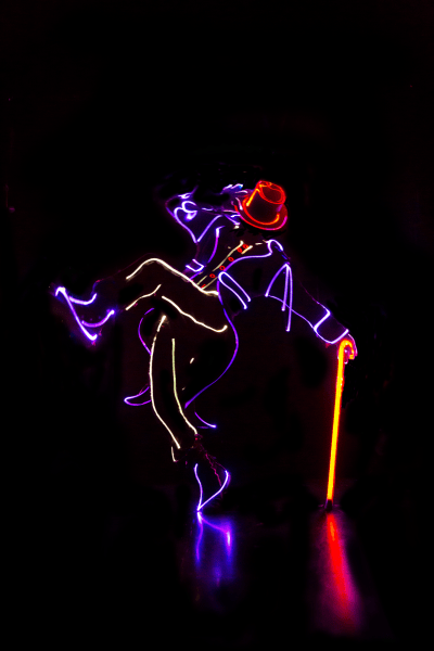 dancer in the dark with lit up costume