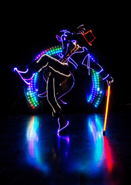 dancer in the dark with lit up costume